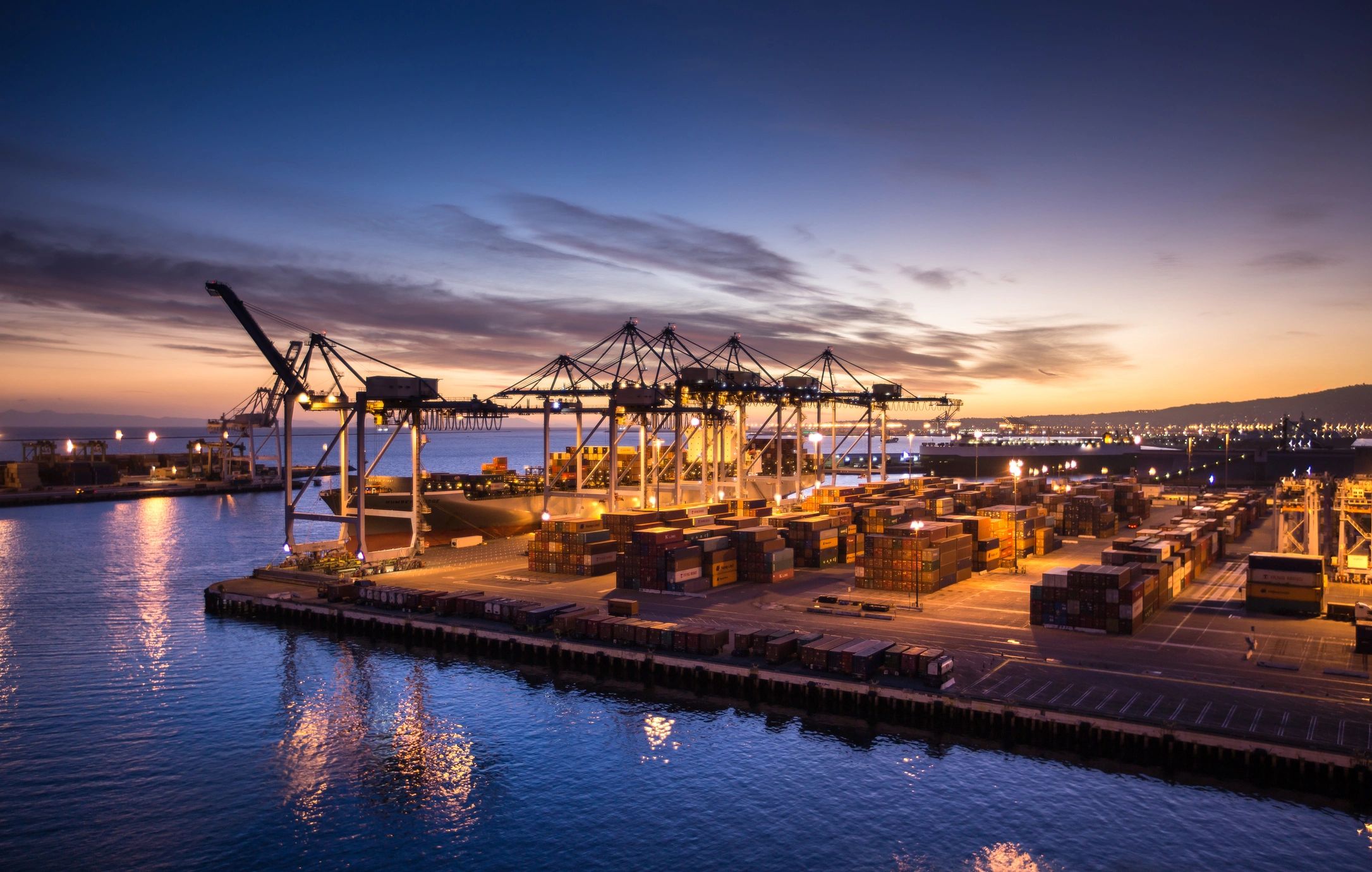 Container terminal and shipping yard at sunset